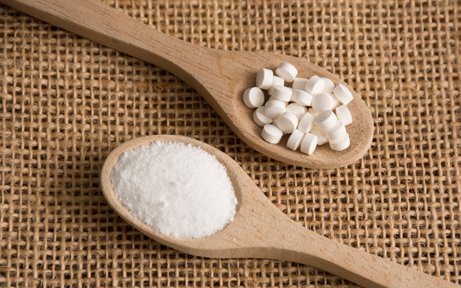 Wooden spoons holding stevia powder and tablets, illustrating stevia and intermittent fasting as a low-calorie sweetener topic.