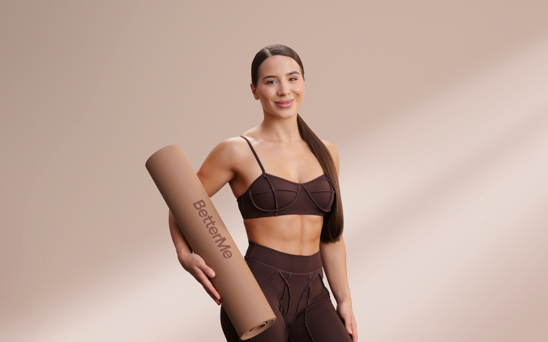 Woman holding a workout mat for a 30-day full body challenge.