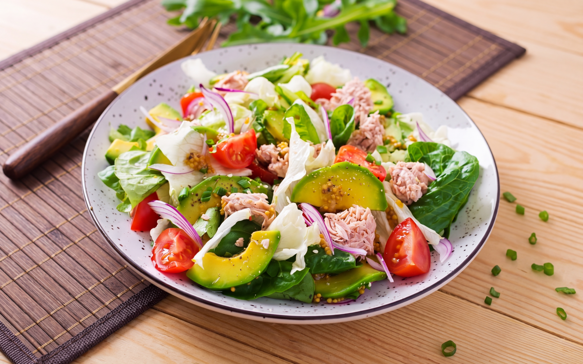 Tuna salad with avocado, tomatoes, leafy greens, and red onion for a 30-day tuna diet.