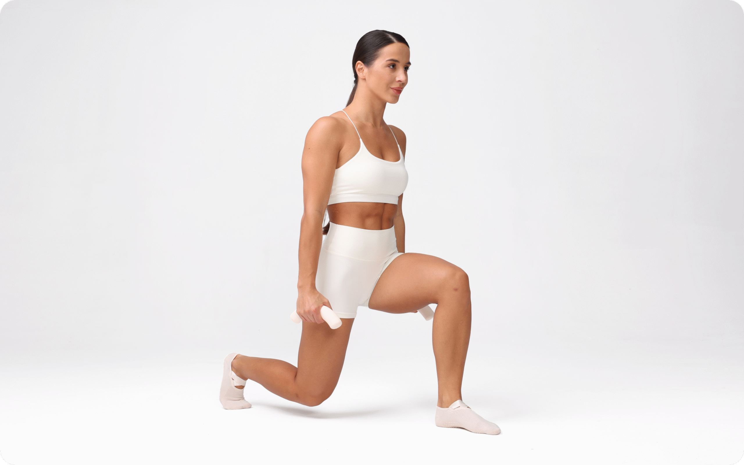 Lessie Fitness model in a white workout set holds a lunge position while gripping a small hand weight, set against a clean white background.