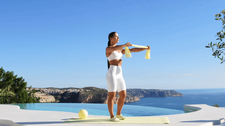 Lessie Fitness performing banded chest openers