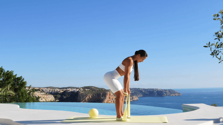 Lessie Fitness performing banded bent over row