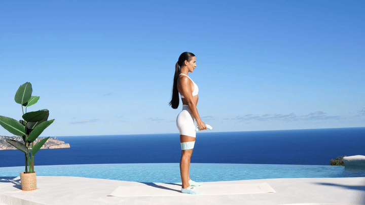 Lessie Fitness performing squat with front raise