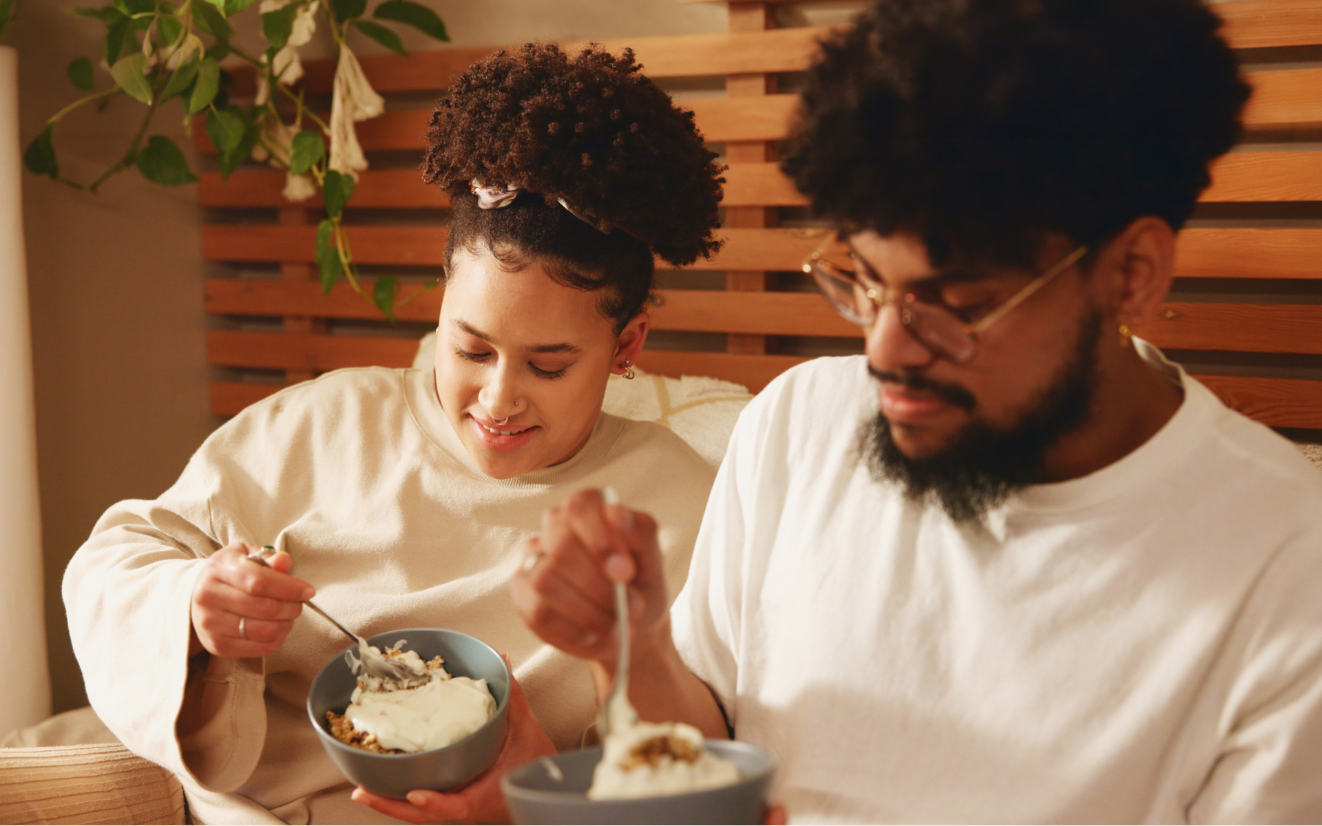 Couple eating bowls of yogurt at home, illustrating does yogurt break a fast and mindful choices during fasting.