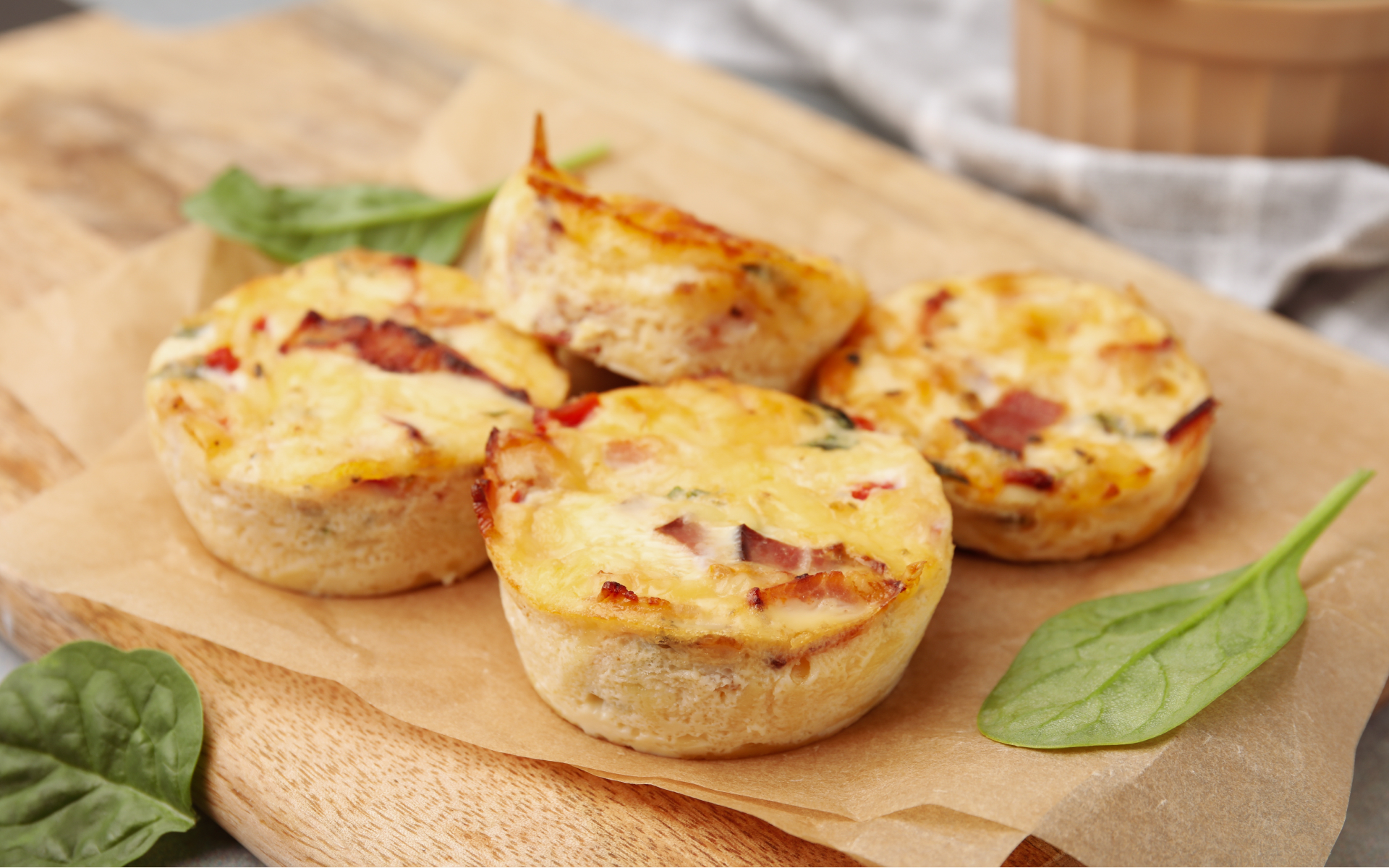 Close-up of baked egg muffins on a wooden board, illustrating 6 high protein recipes for weight loss with a simple, portion-friendly meal idea.