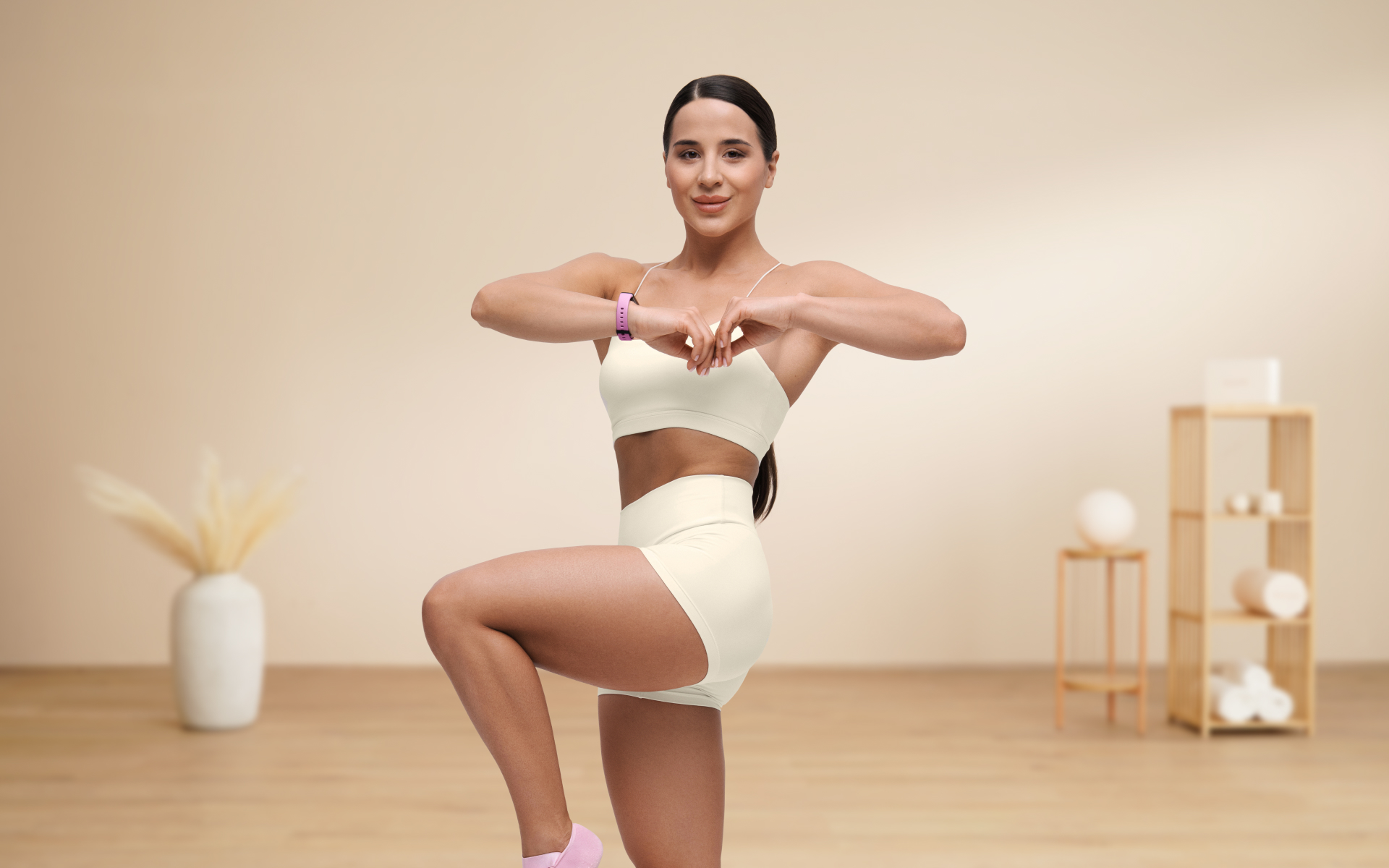 Woman doing a high-knee exercise in a minimalist room, illustrating HIIT workouts at home without equipment with a simple bodyweight cardio move.