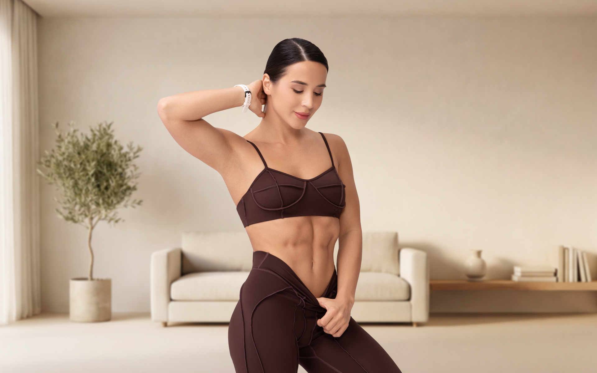Woman in workout wear posing in a bright living room, illustrating a 12 week weight loss workout plan lifestyle concept.
