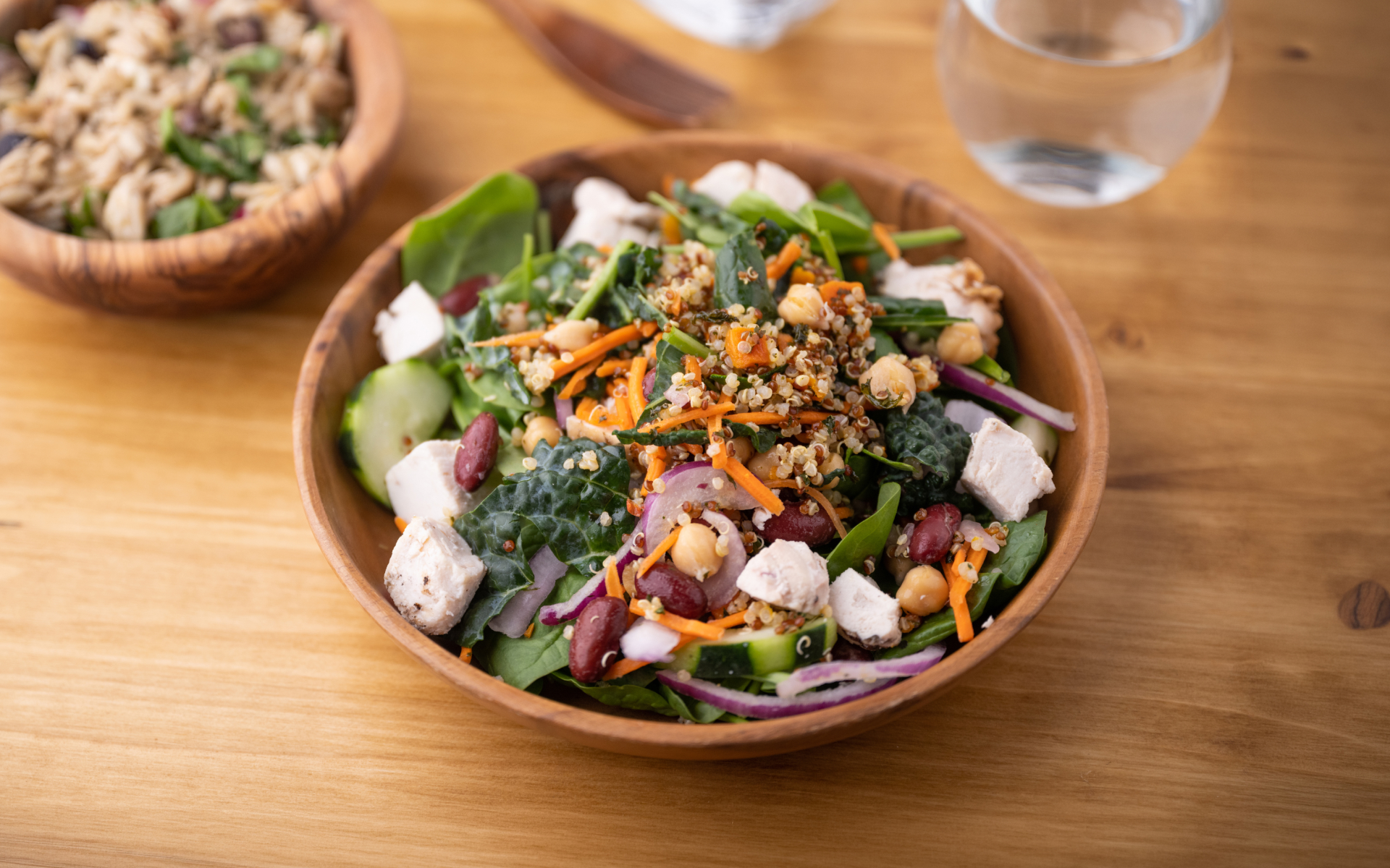 Quinoa, chickpea, bean, vegetable, and chicken salad served as part of a sample Mediterranean diet meal plan.